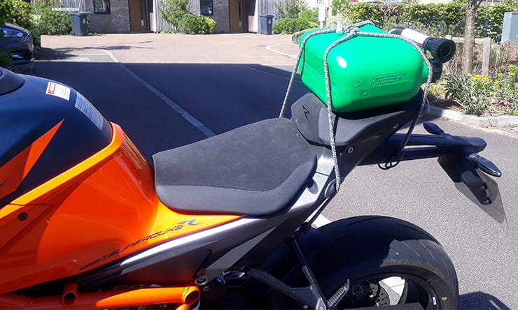 If your bike has a small fuel tank carrying a reserve supply of petrol is a good idea. Here's the best ways to carry extra fuel & common questions answered.